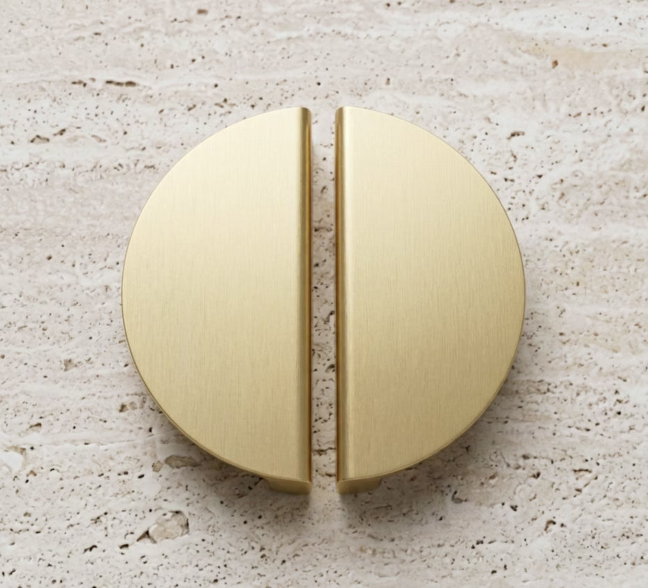 Gold half moon handles - top view- on a stone textured benchtop