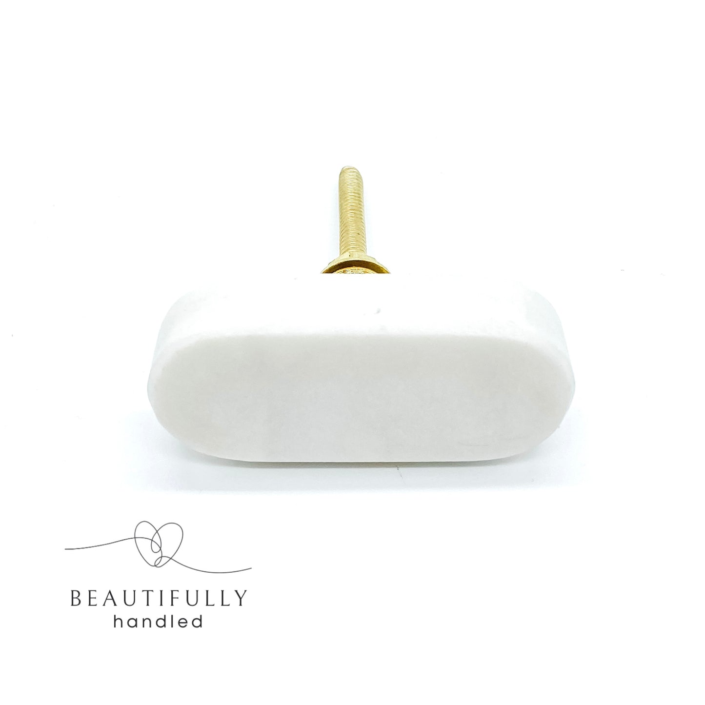 oblong shaped marble drawer handle with brass bolt on plain white background