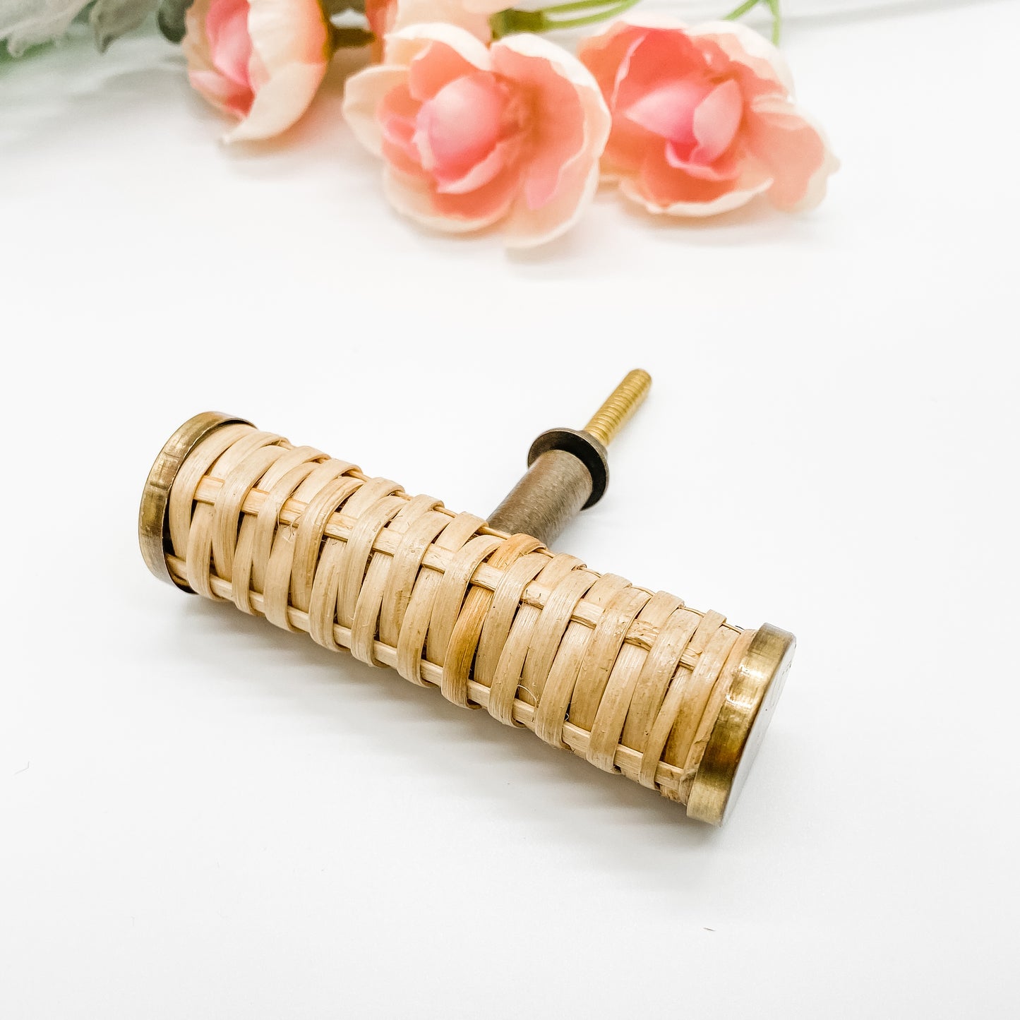 natural round rattan cabinet hanldle t-bar with brass edges on white background