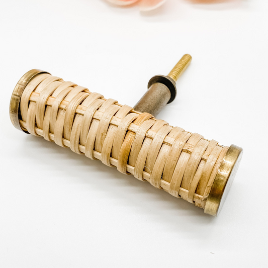 small rattan handle with brass edges t-bar style on white background front angle