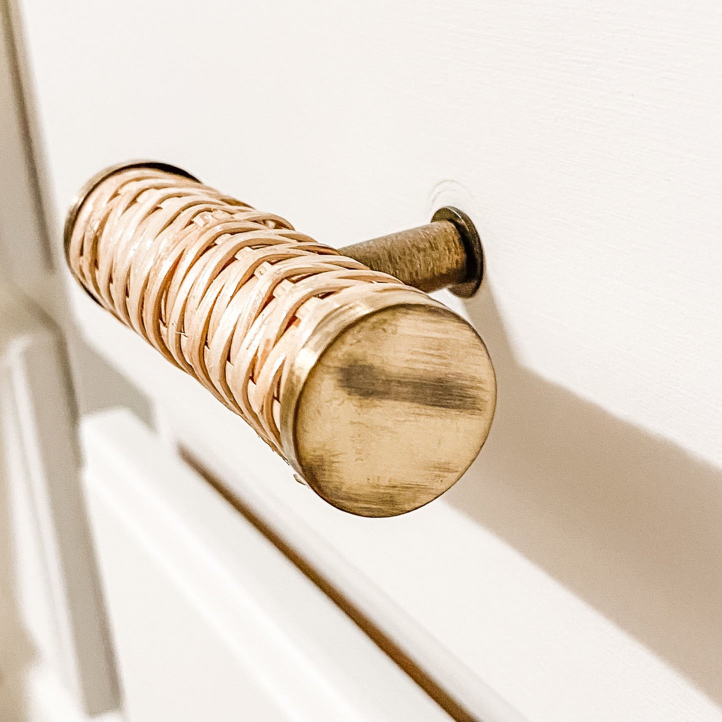 round small rattan handle on white furniture