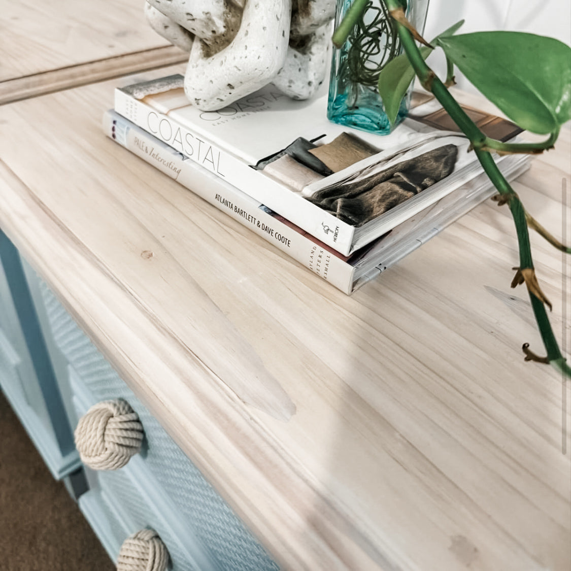 blue coastal bedside table close up with timber top and white cotton knot drawer knobs