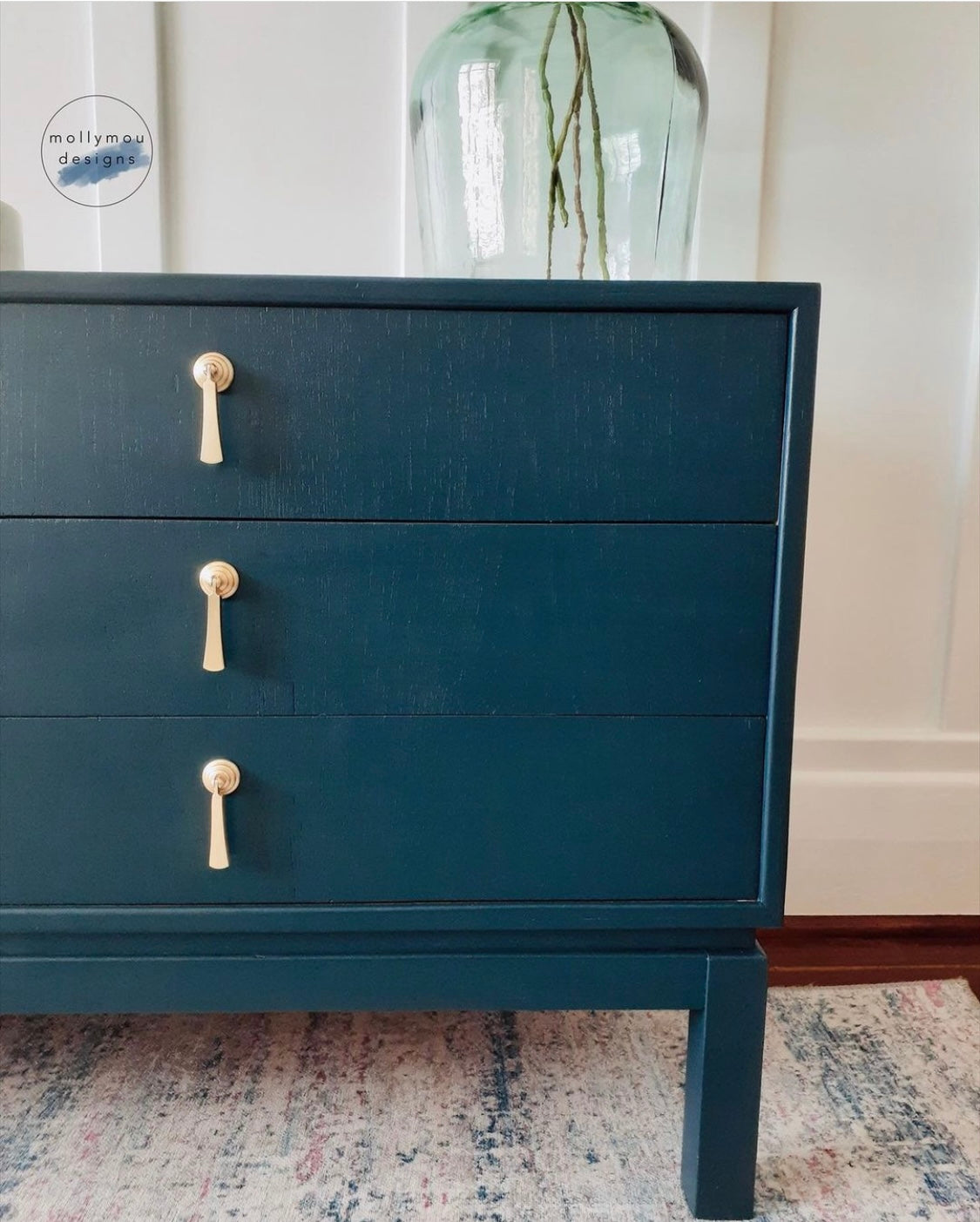 dark blue painted chest of drawers with gold drop drawer handles