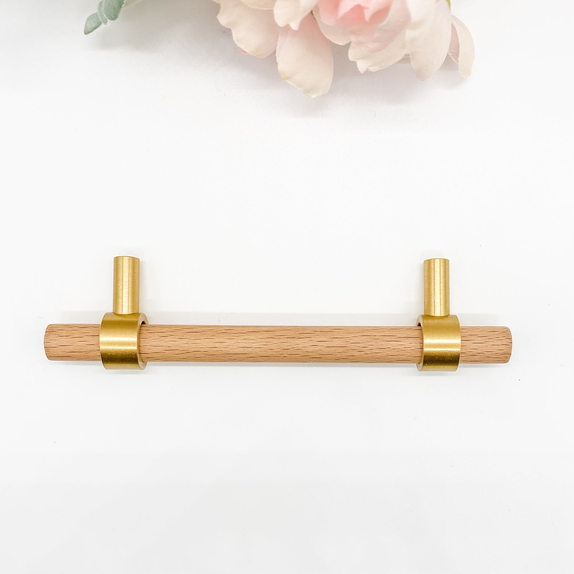 128mm Wooden drawer pull with gold hardware on a white background