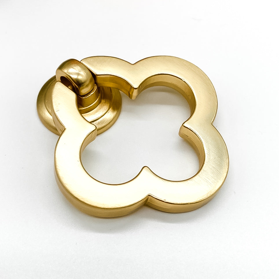 Brushed gold flower shaped clover leaf drawer handle on white background