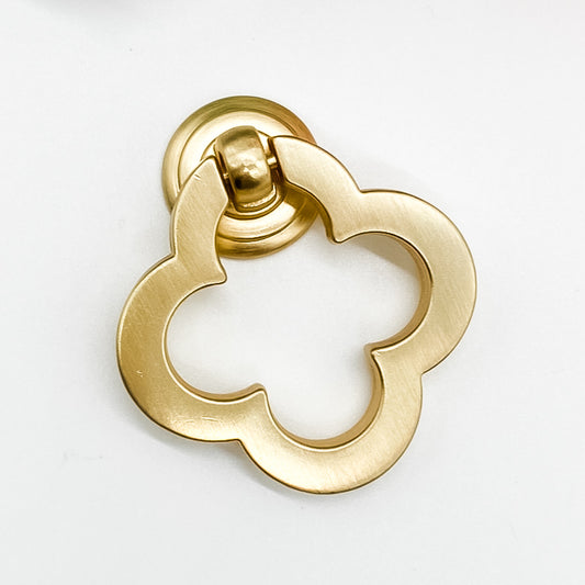 Brushed gold flower shaped clover leaf drawer handle on white background