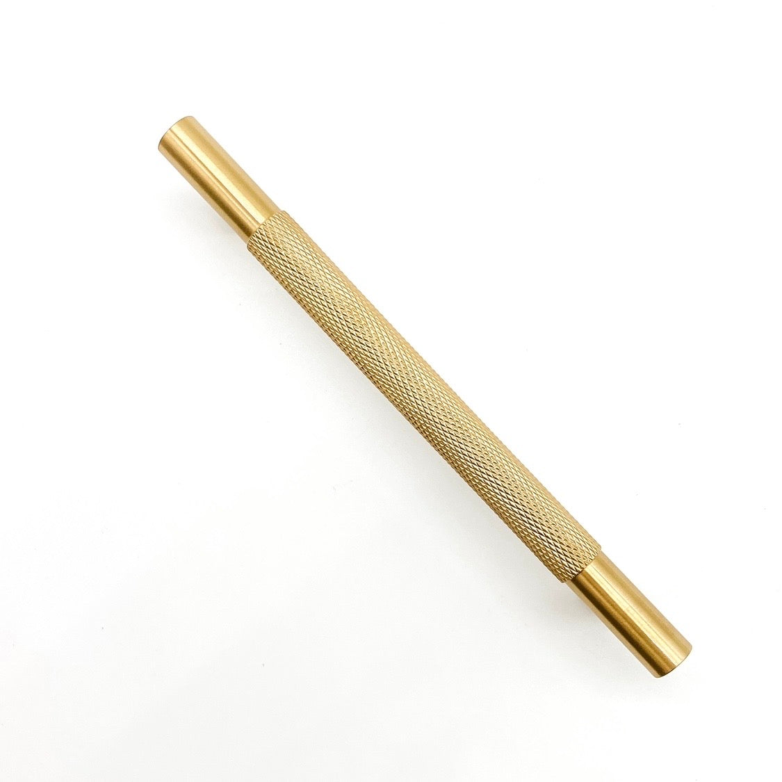 Knurled brass cabinet handle 128mm on a plain white background