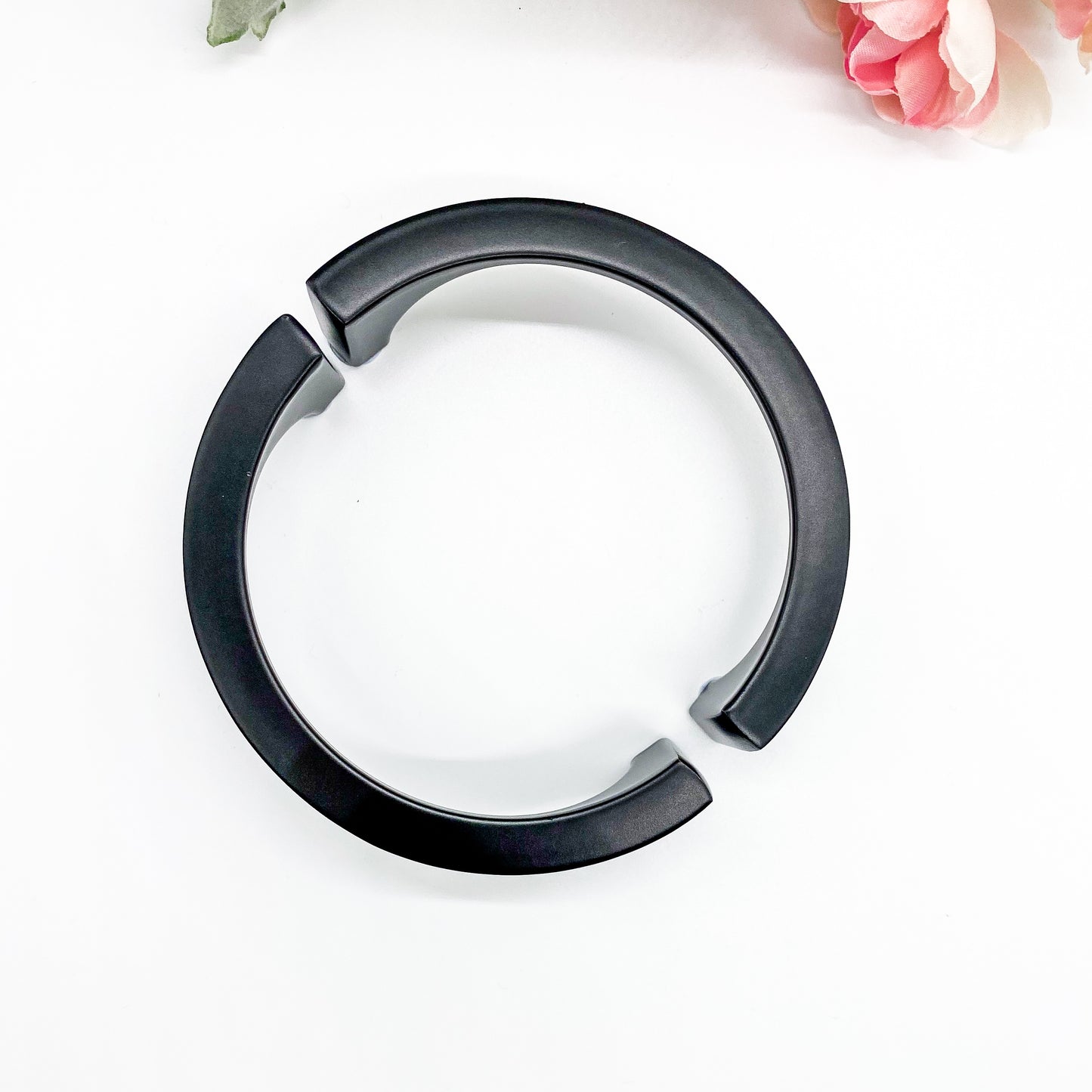 Black half moon handle on plain white background