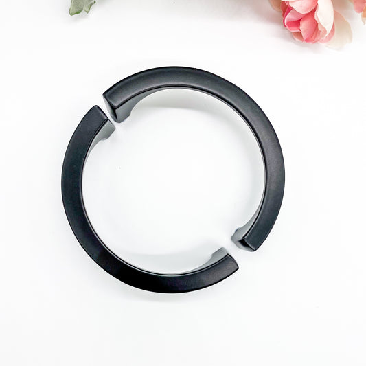 Black half moon handle on plain white background