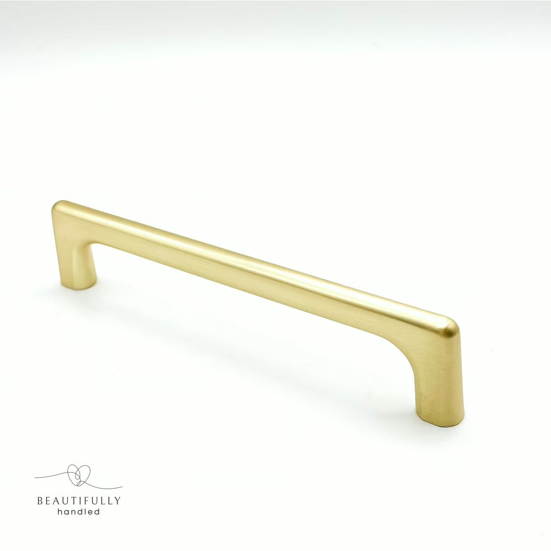 Brushed brass cabinet handle with square edges on white background