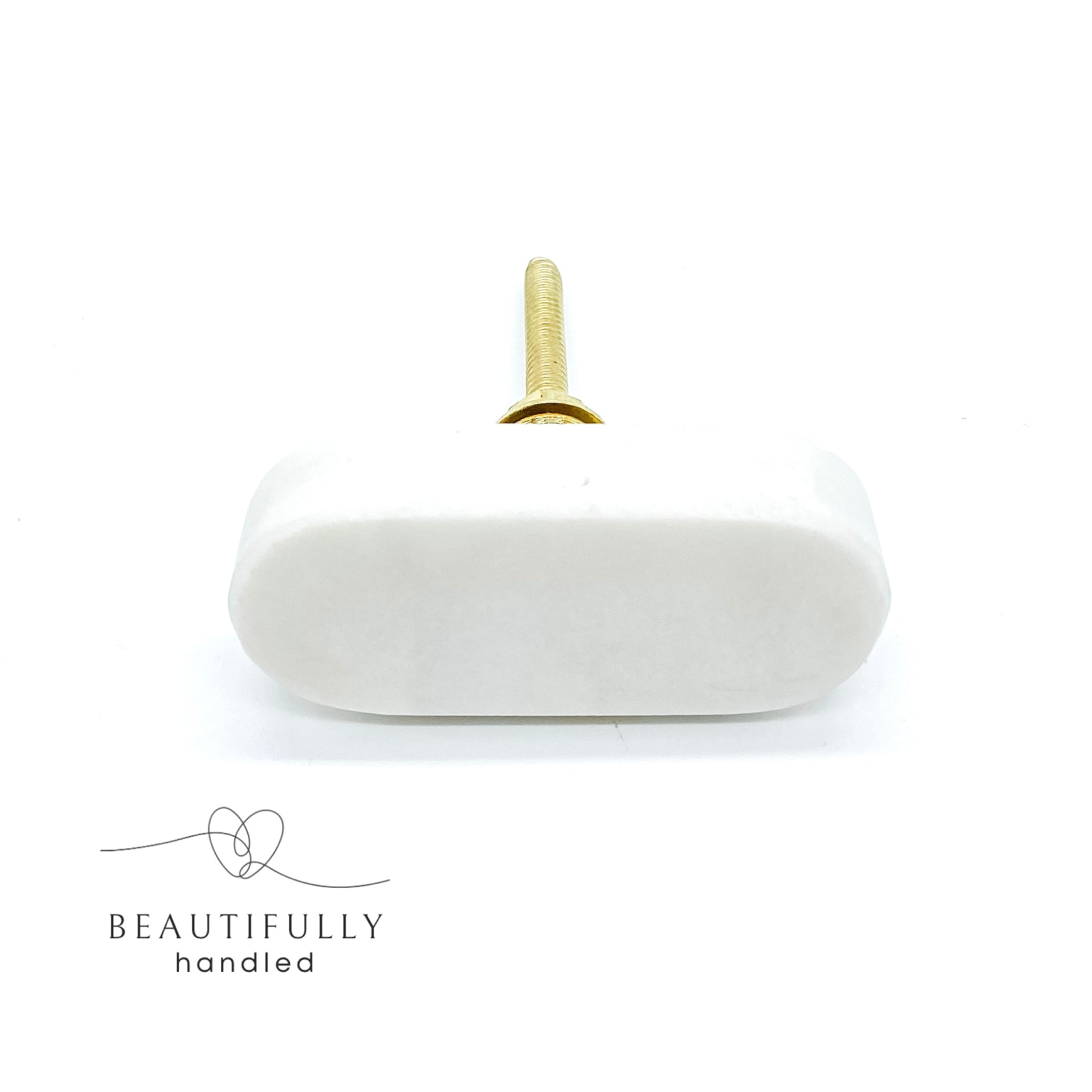 oblong shaped marble drawer handle with brass bolt on plain white background