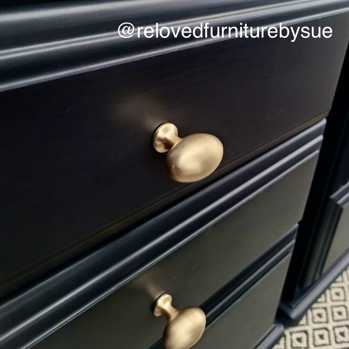 close up of pair of black bedside tables with brushed gold drawer knobs 