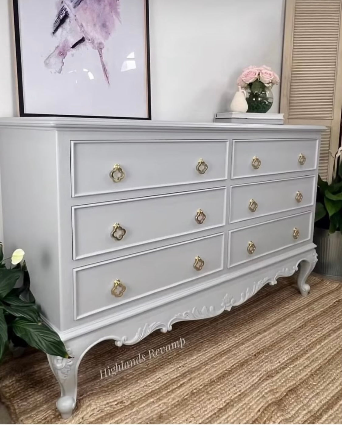 clover leaf gold drawer handles displayed on large beige chest of drawers on rug in living room setting