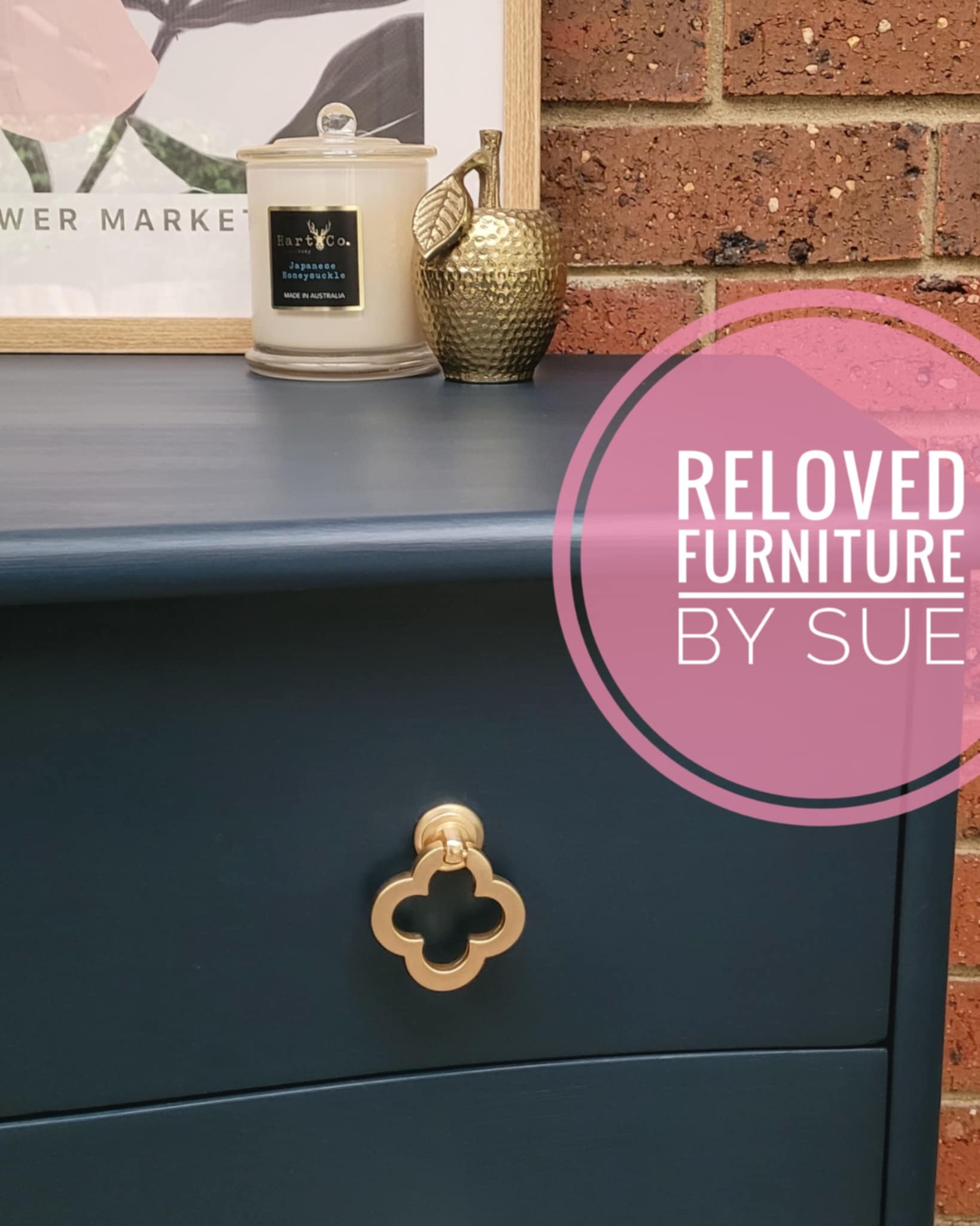 Brushed gold flower shaped clover leaf drawer handle close up picture on navy blue chest of drawers
