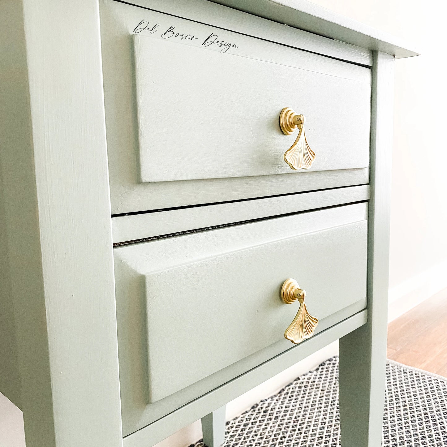 gold ginkgo leaf drawer pulls on sage green bedside tables