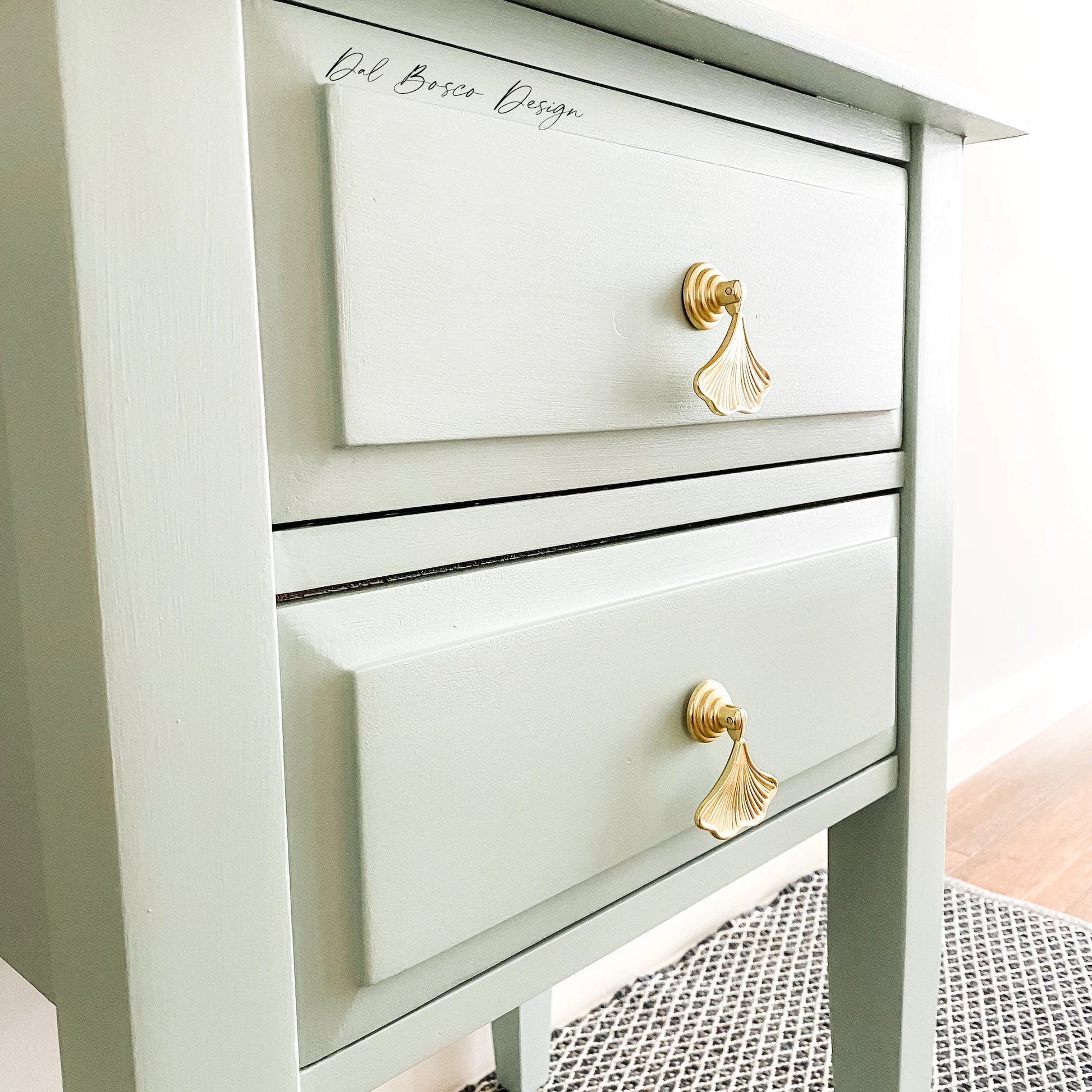 gold ginkgo leaf drawer pulls on sage green bedside tables