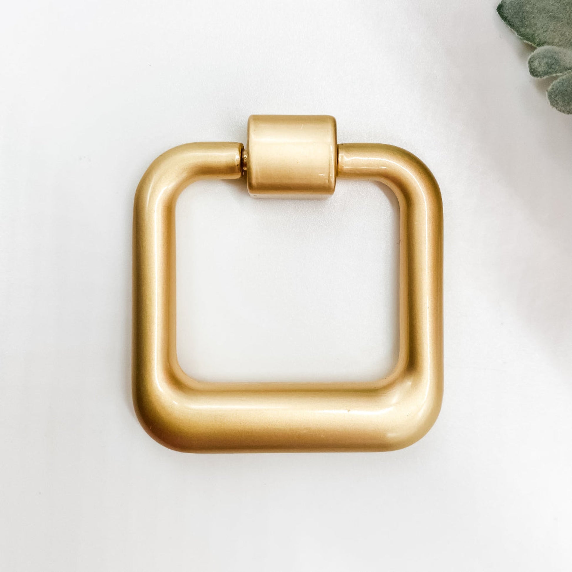 Gold square drop pull handle on white background