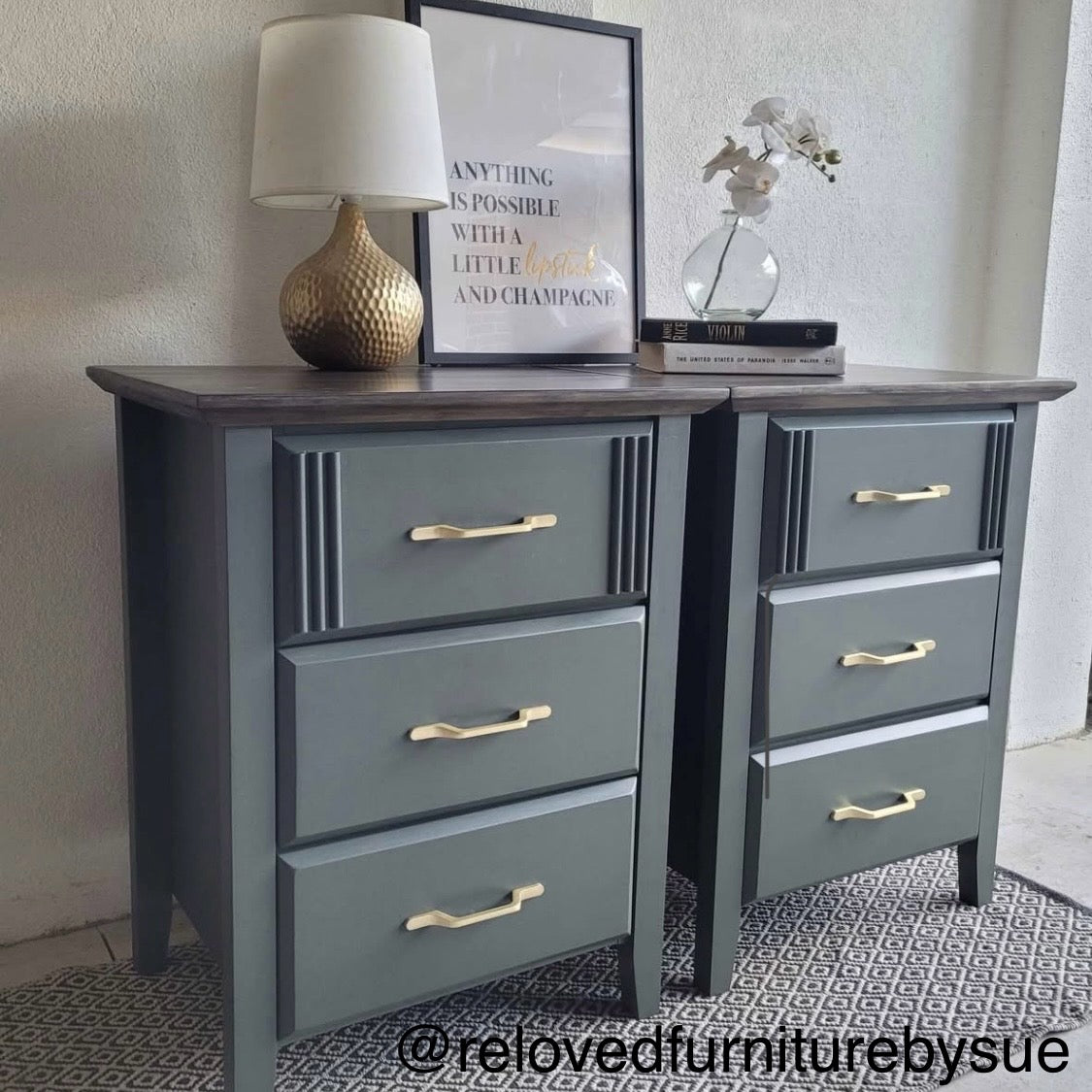 Green dresser with gold handles on a patterned rug, featuring decor items like a lamp and framed picture.