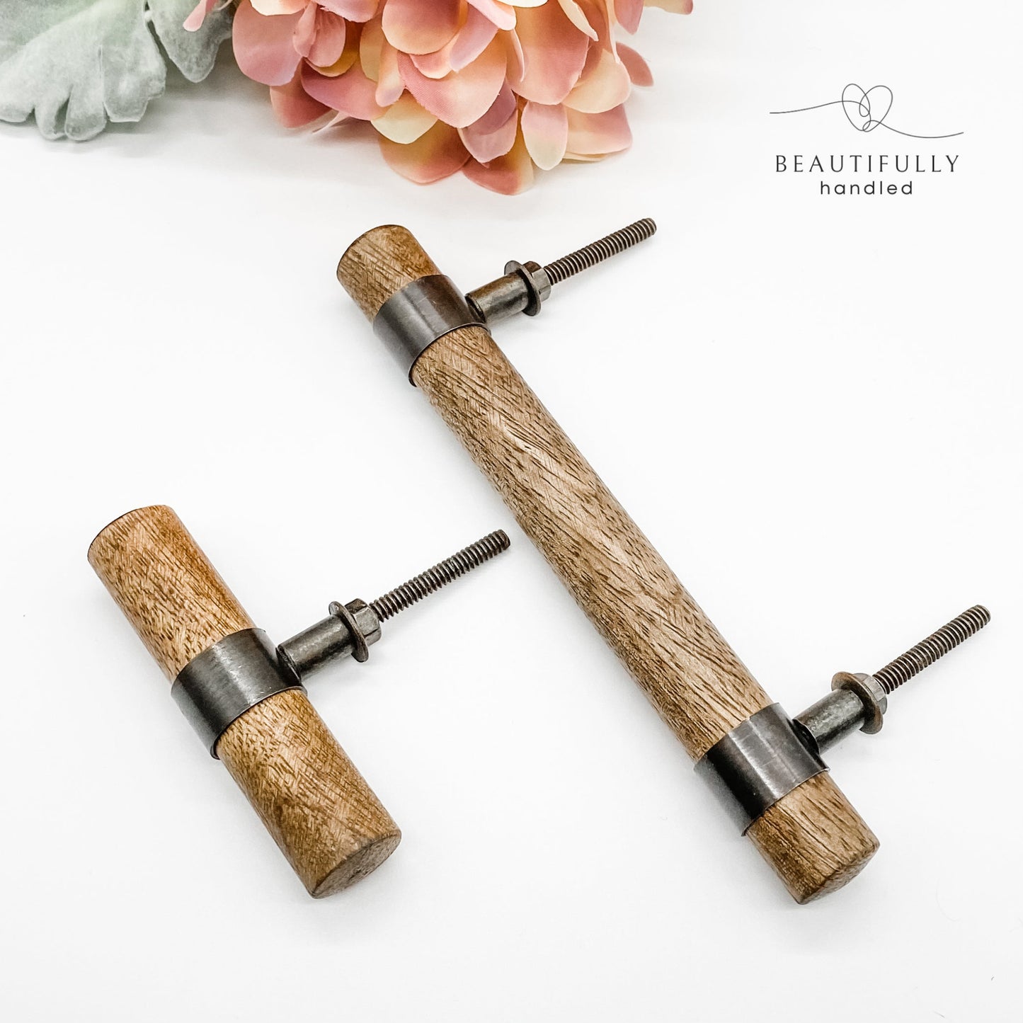timber drawer handle with metal clasps and matching t-bar handle on white background