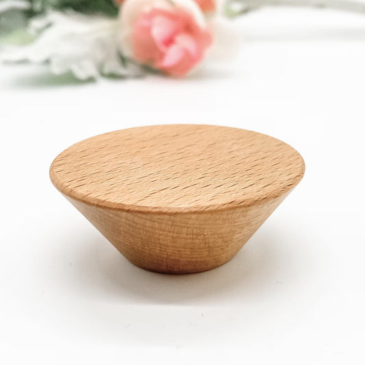 Round Wooden drawer knob with tapered edges with diameter 50mm on a white surface