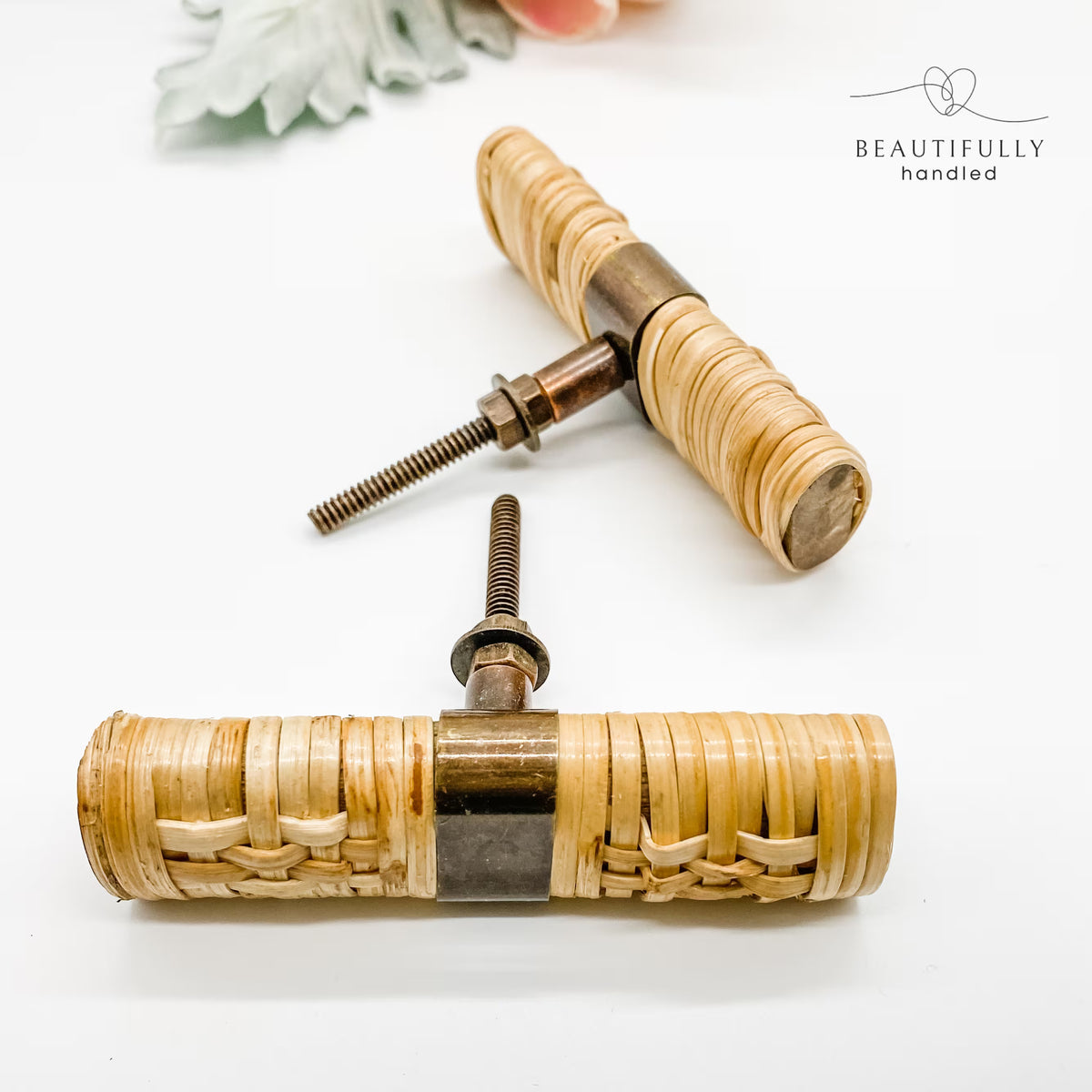 2 rattan woven drawer handles on plain white background