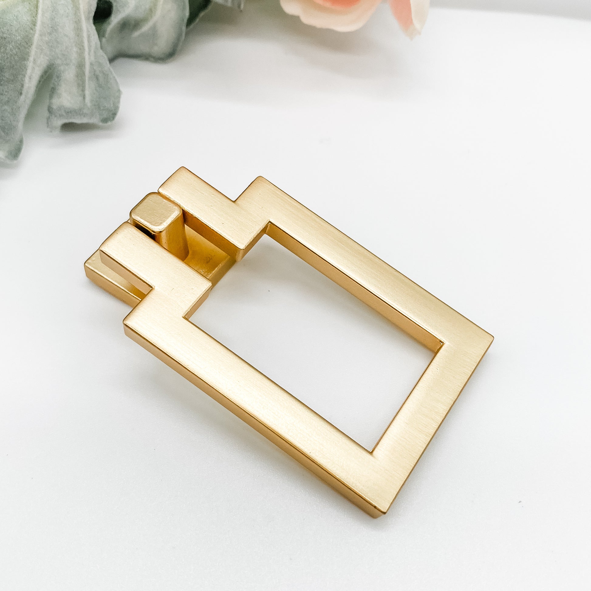 rectangular brushed gold drop pull drawer handle side angle on white background