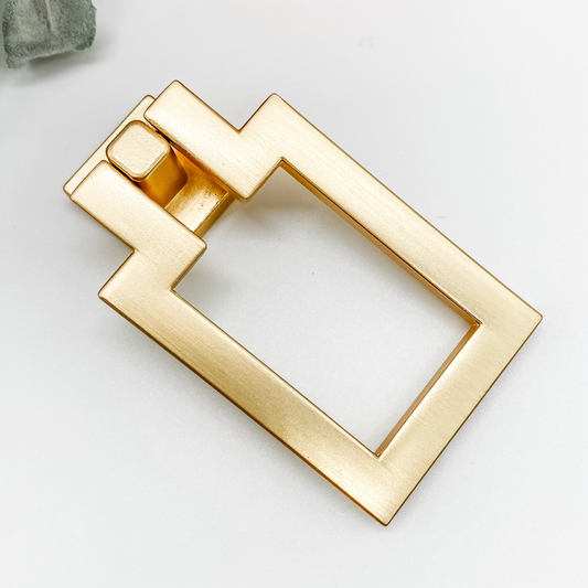 rectangular brushed gold drop pull drawer handle front angle on white background