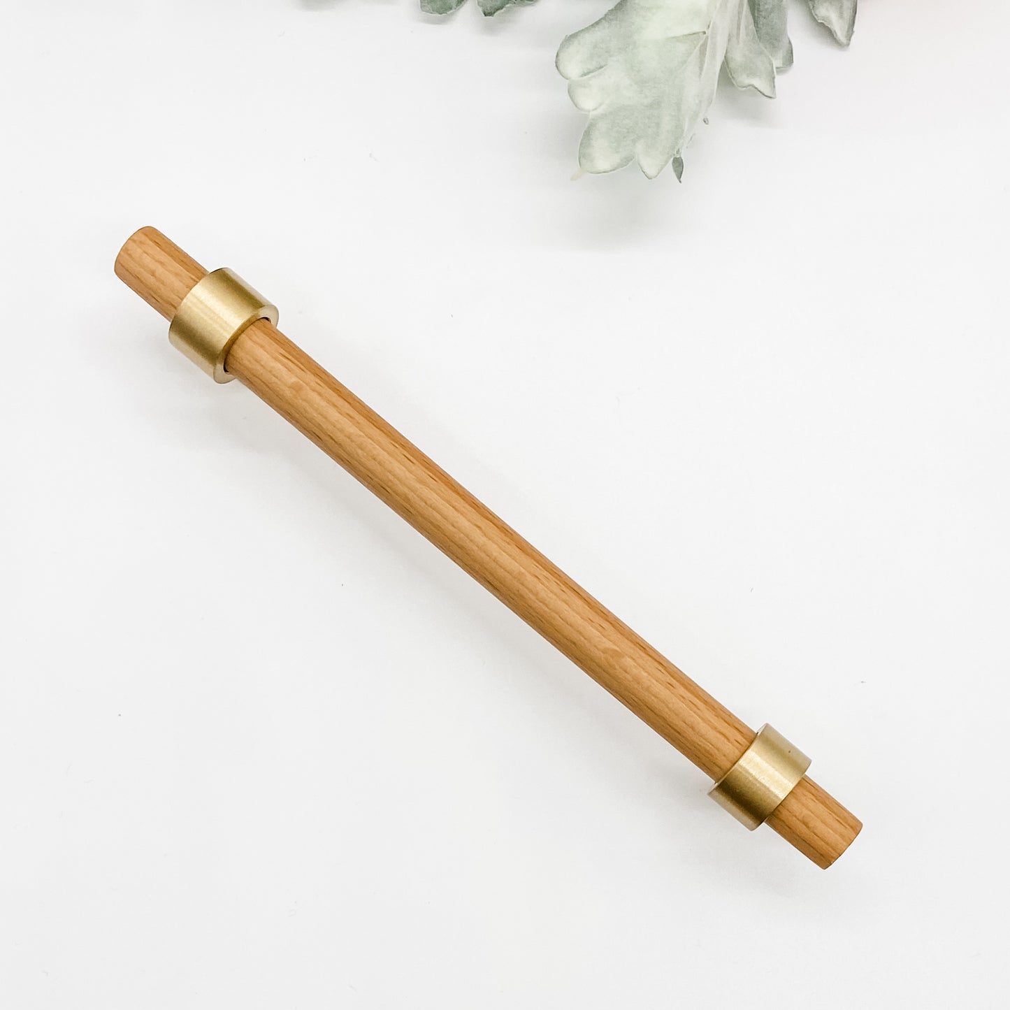 timber and brass 160mm kitchen handle on white background