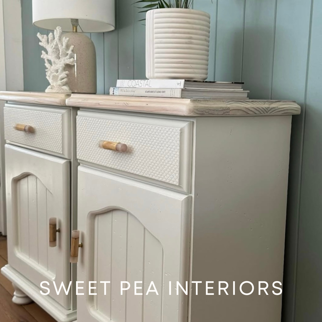Timber and resin drawer handles on beige coastal bedside tables in front of green VJ panelled wall with coastal stylng