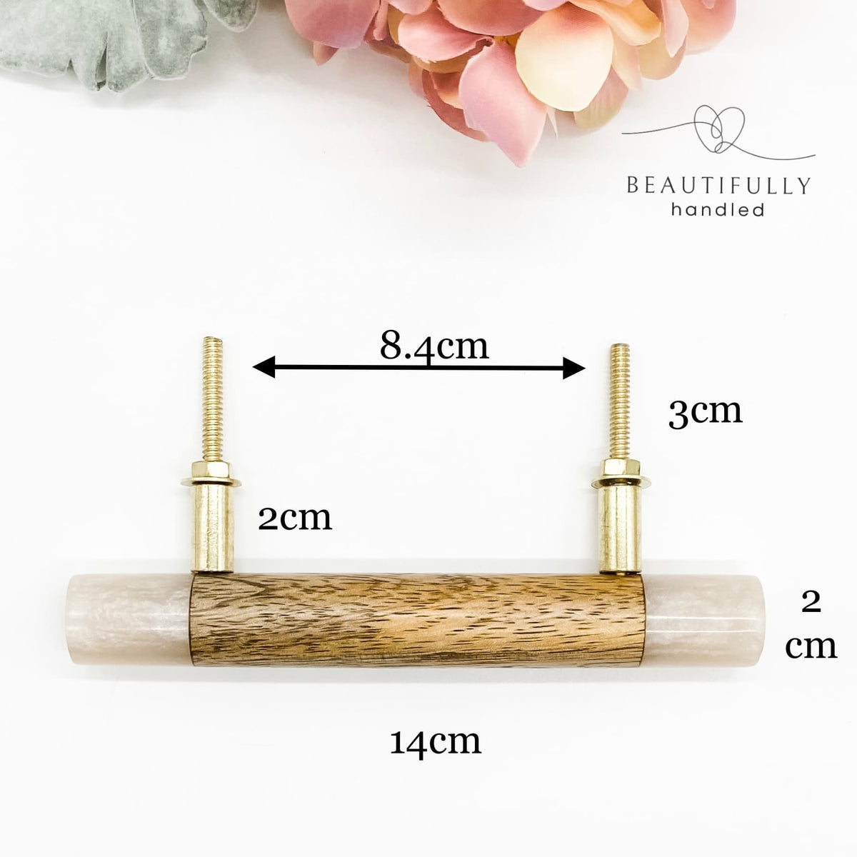 A timber drawer pull handle featuring a light beige resin casing and a natural wood center inlay, with two brass mounting posts. The image includes dimension annotations