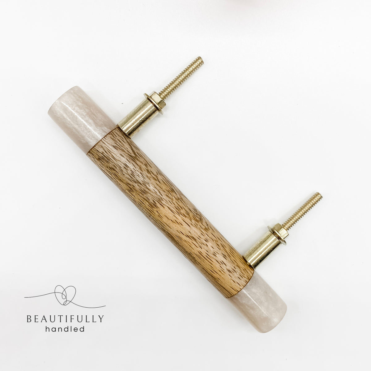 A timber drawer pull handle featuring a light beige resin casing and a natural wood center inlay, with two brass mounting posts.