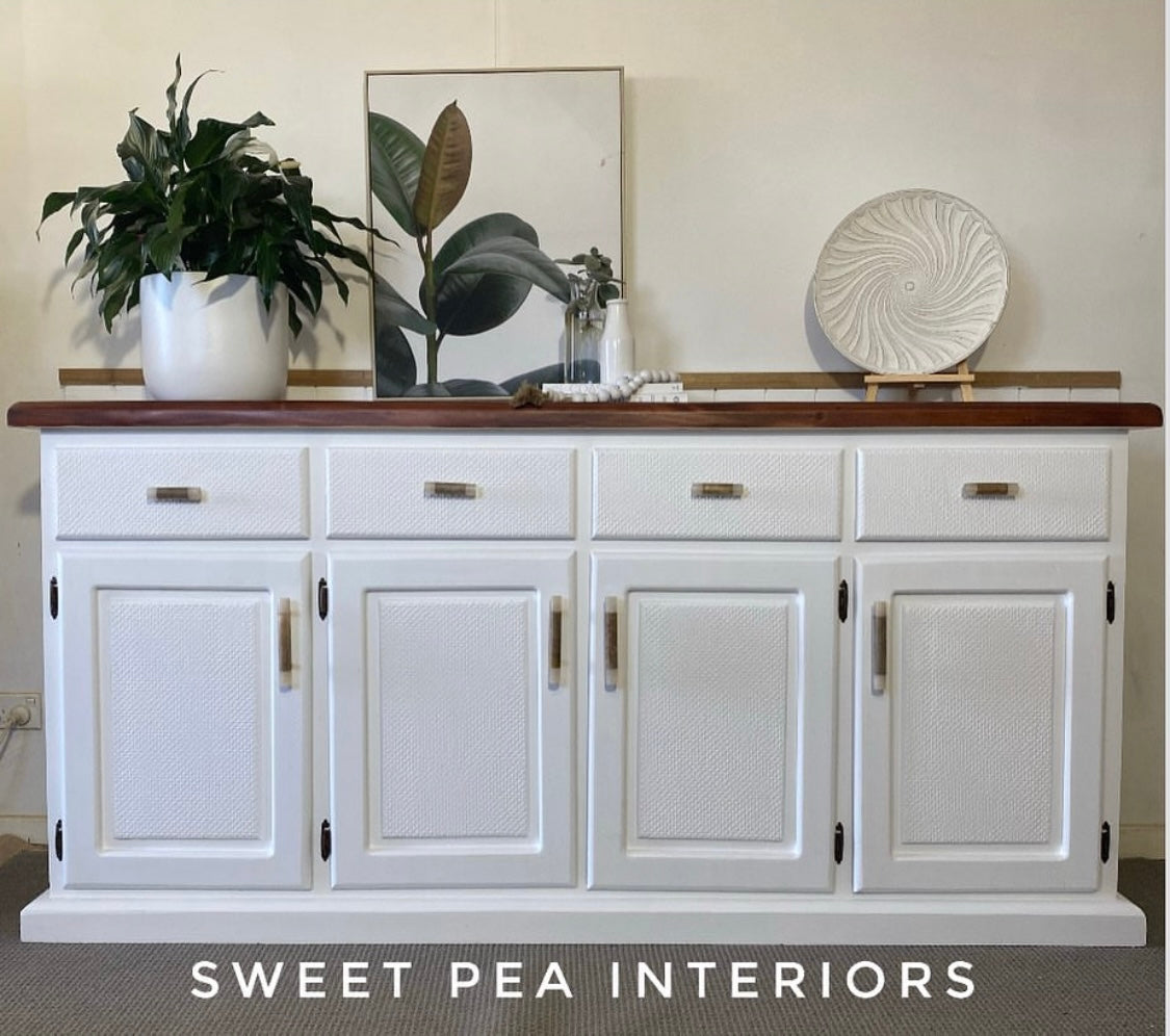 white timber buffet showcasing timber and resin drawer handles and t-bars with pot plant and decor items on top of the buffet
