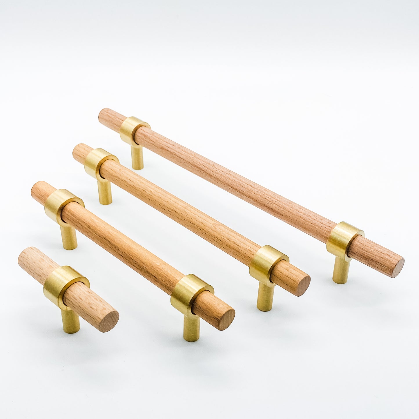 Wooden cabinet handles with brass accents on a white background