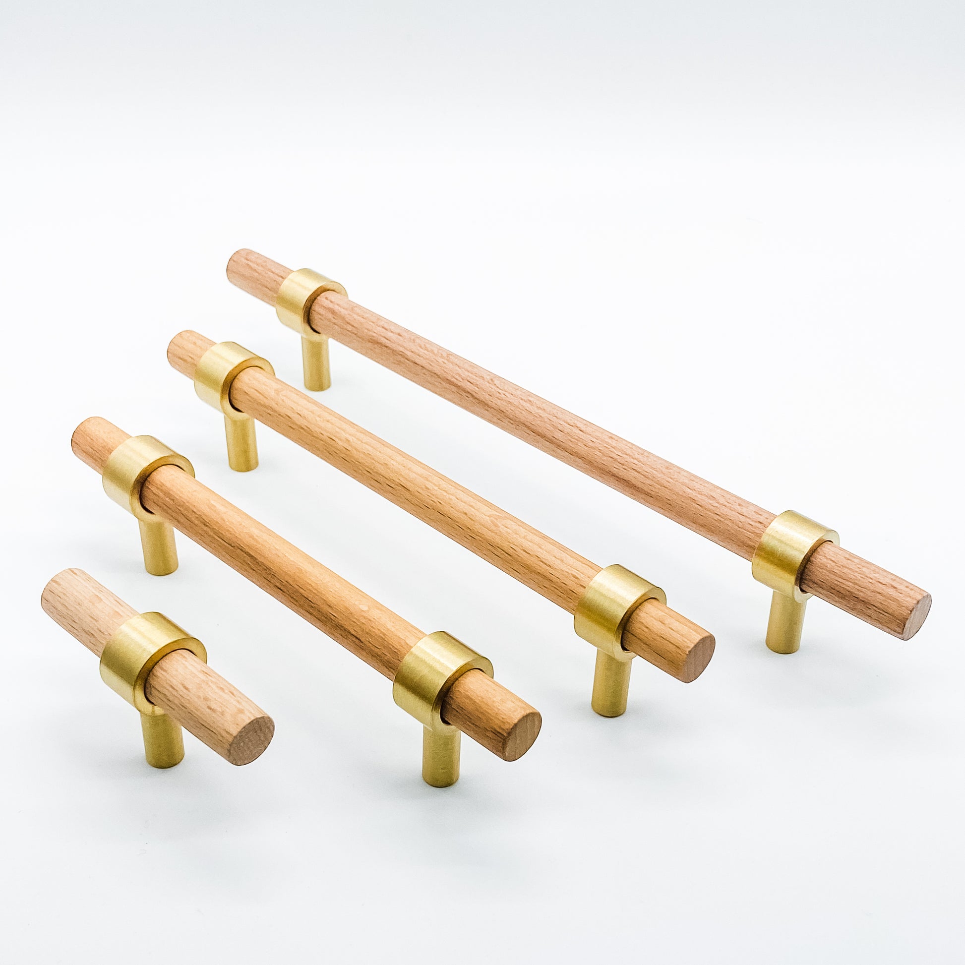 Wooden cabinet handles with brass accents on a white background