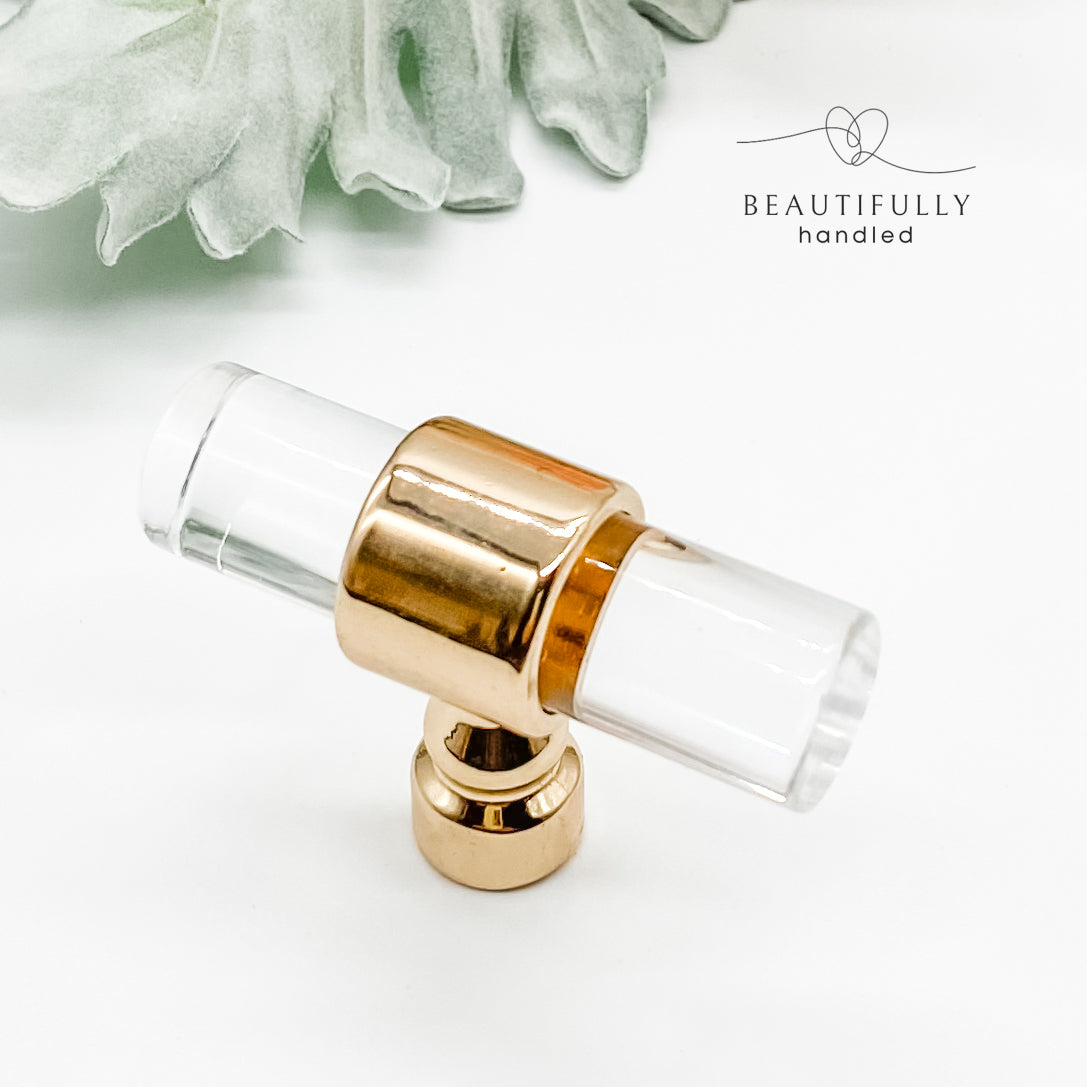 clear acrylic drawer pulls t bars with gold clasps on plain white background