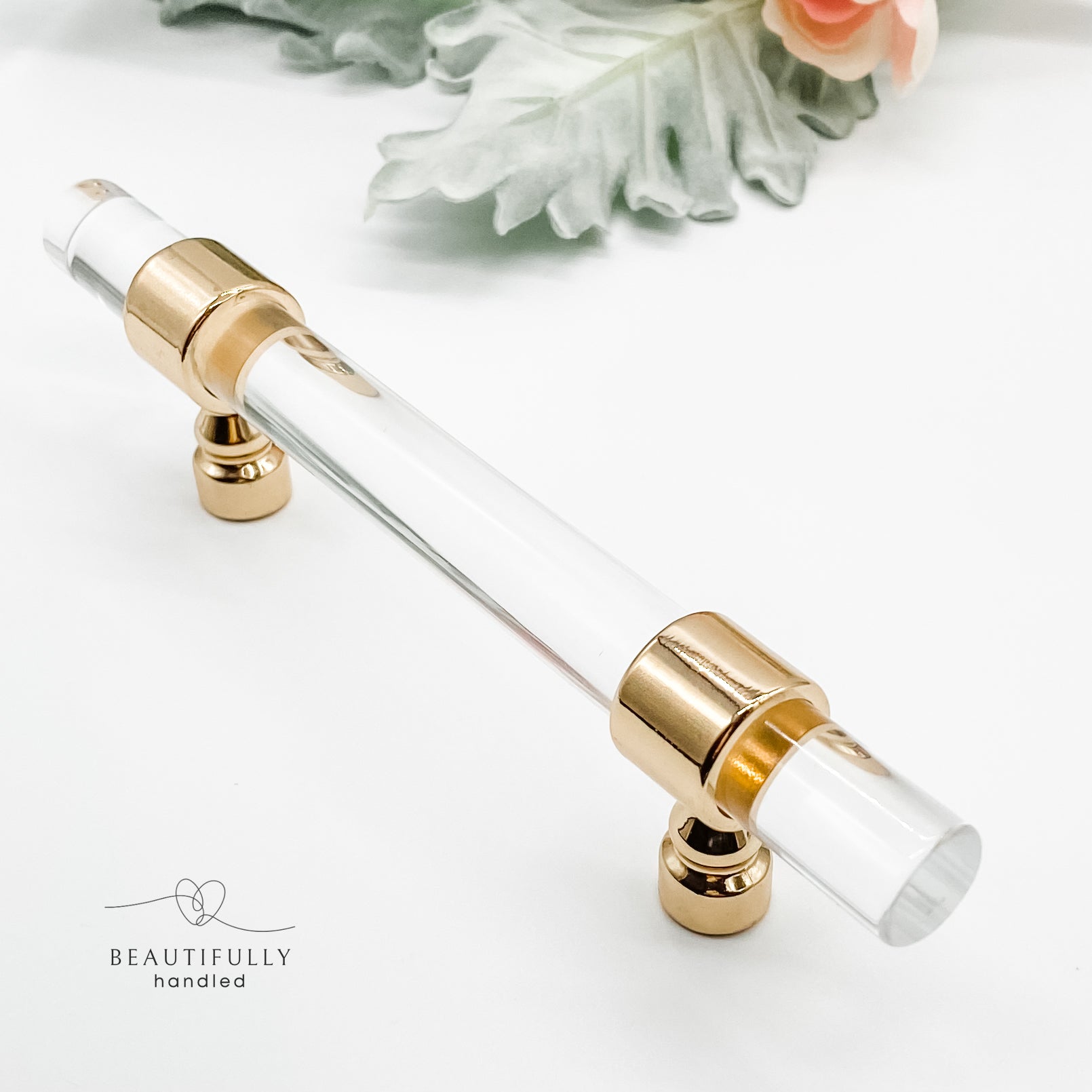 96mm clear acrylic with gold clasp drawer handle on plain white background