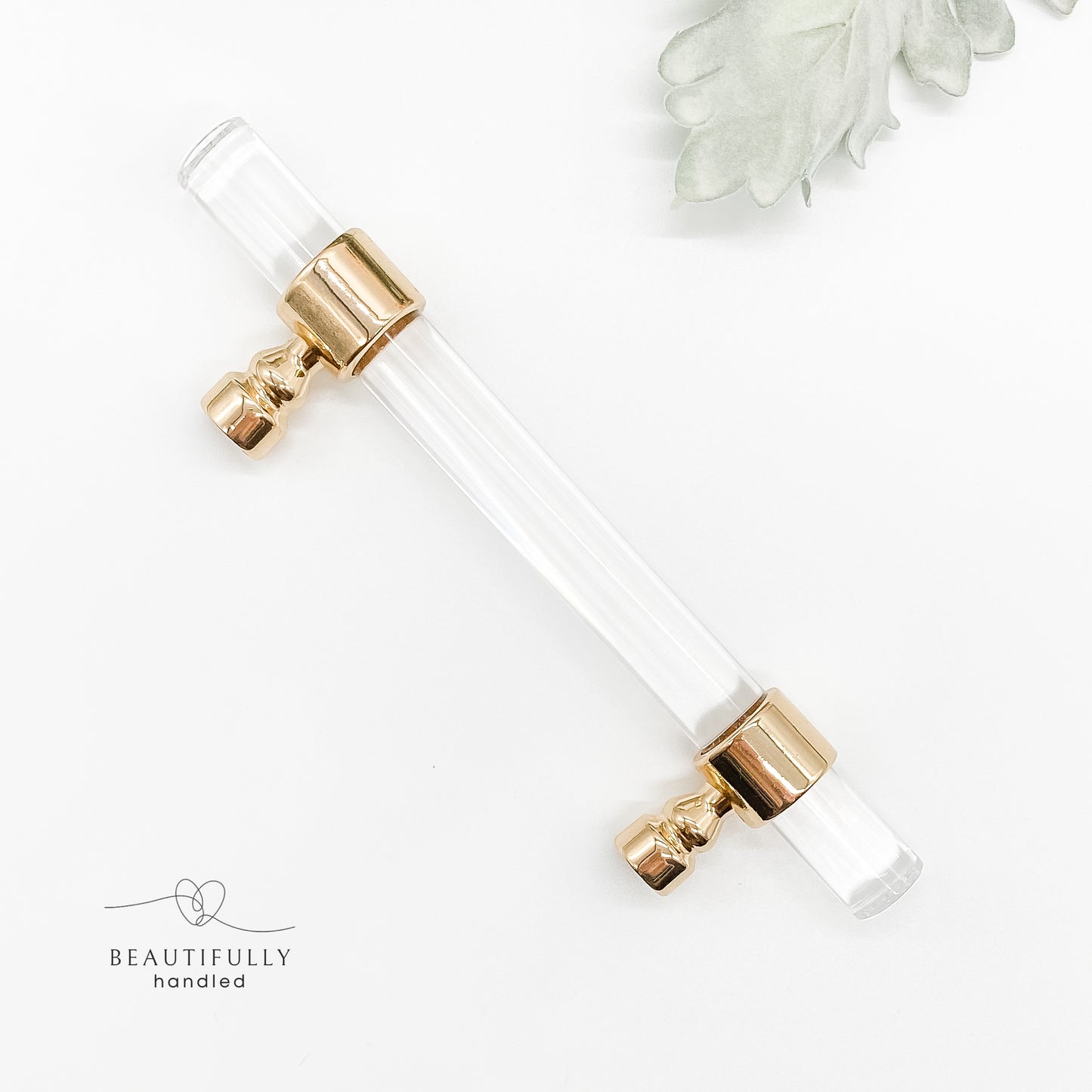96mm clear acrylic with gold clasp drawer handle on plain white background