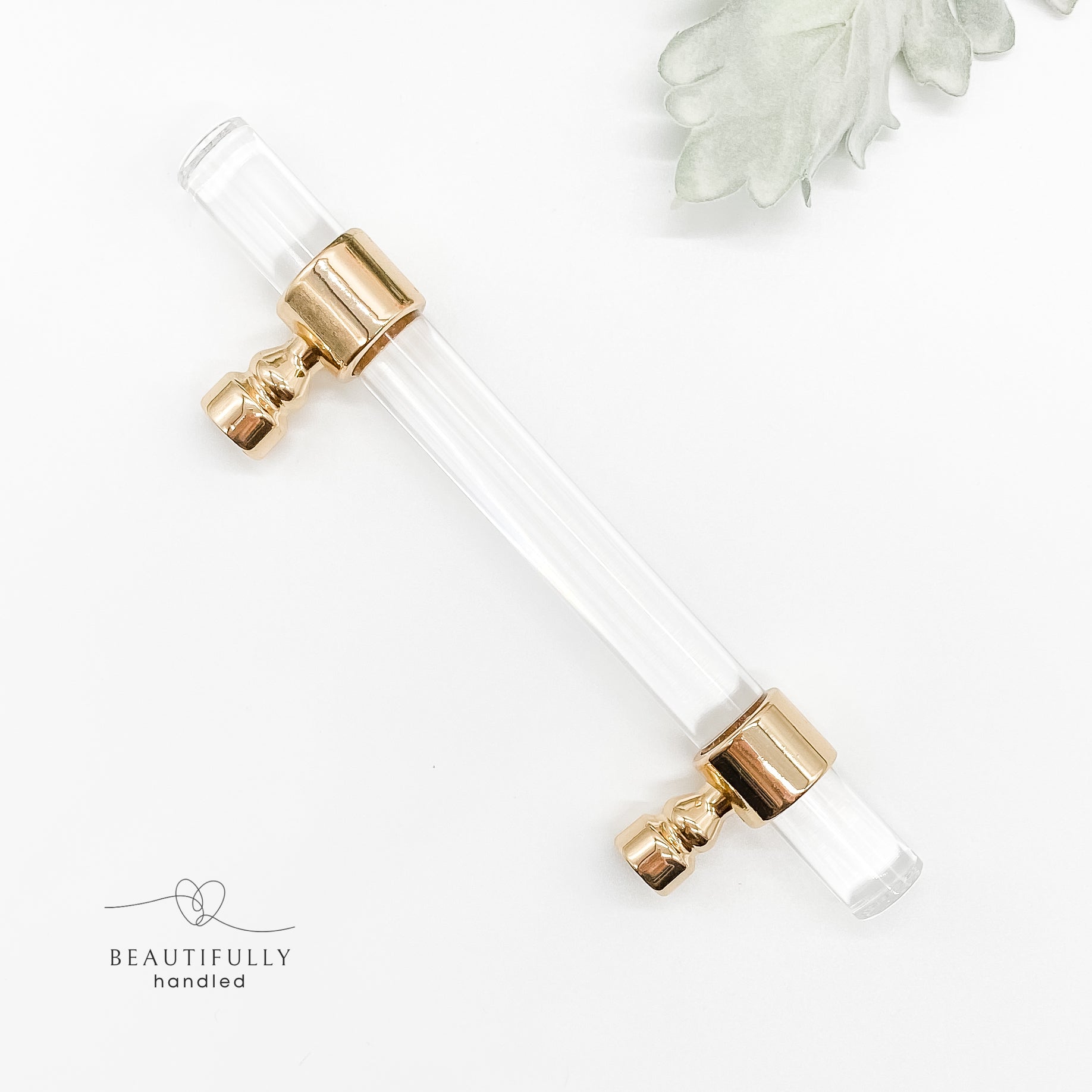 96mm clear acrylic with gold clasp drawer handle on plain white background