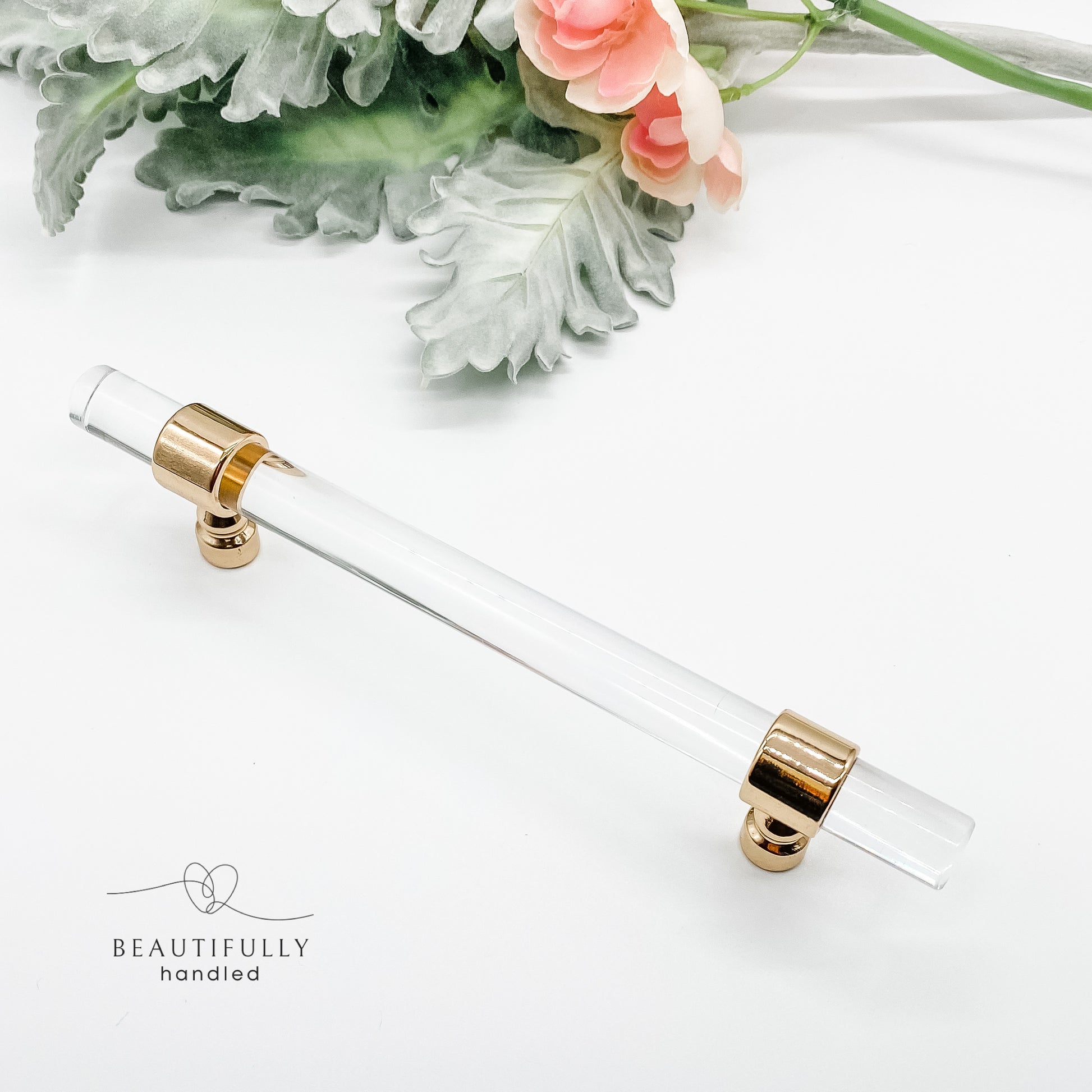 128mm clear acrylic with gold clasp drawer handle on plain white background