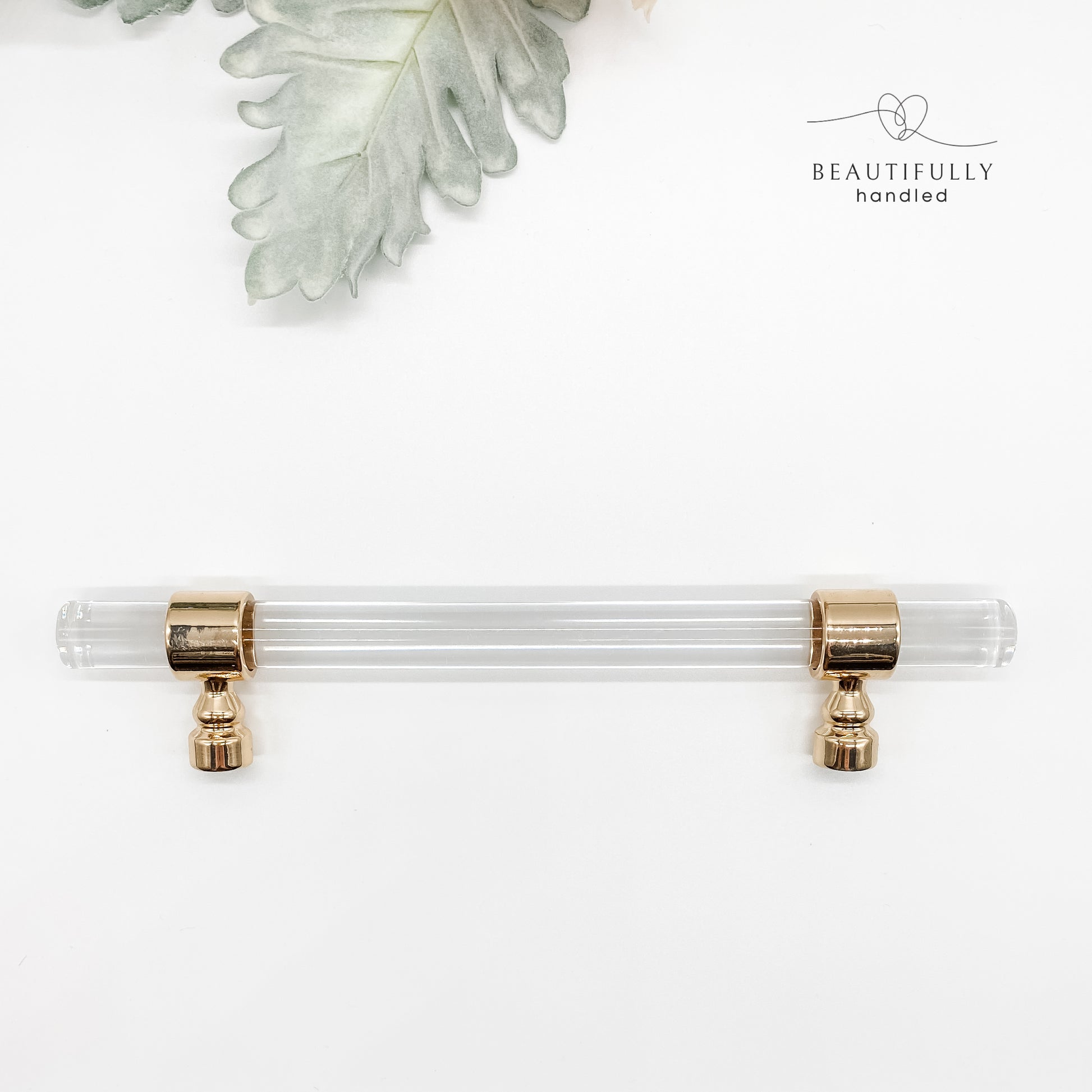 128mm clear acrylic with gold clasp drawer handle on plain white background