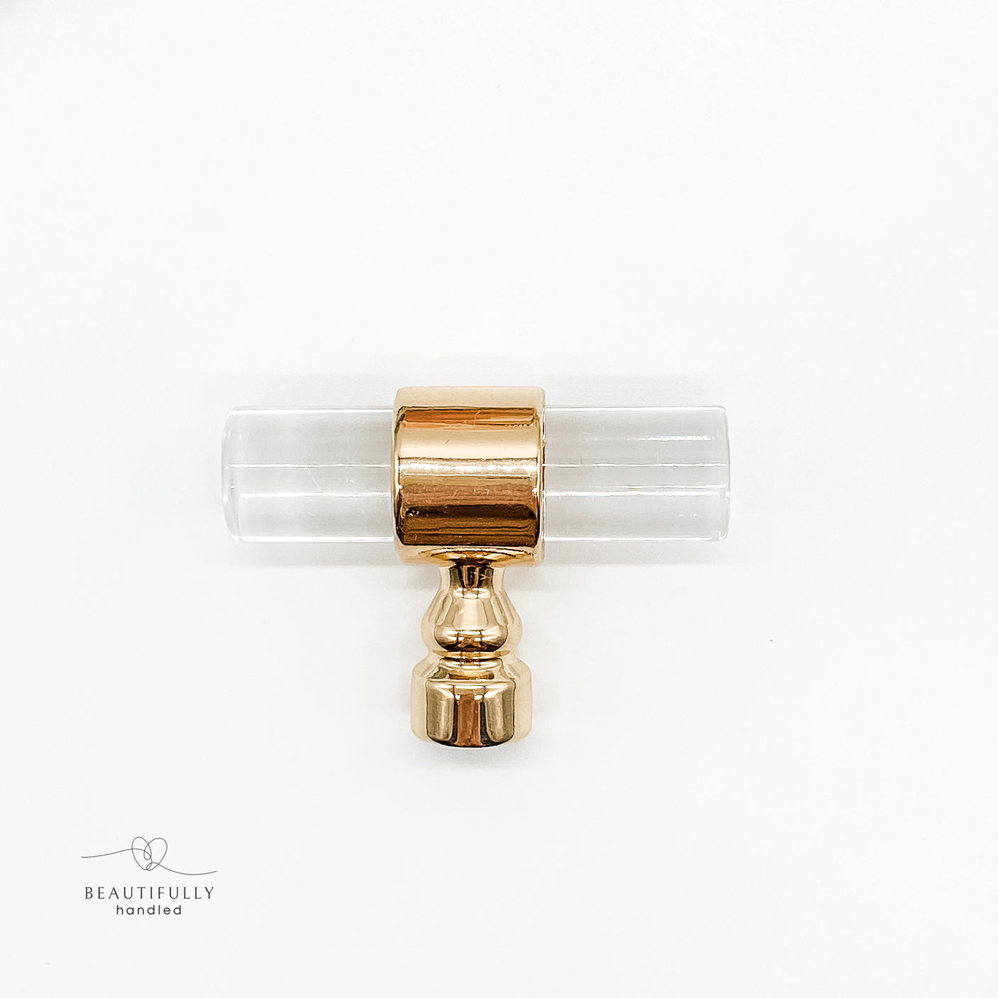 clear acrylic drawer pulls t bar with gold clasps on plain white background