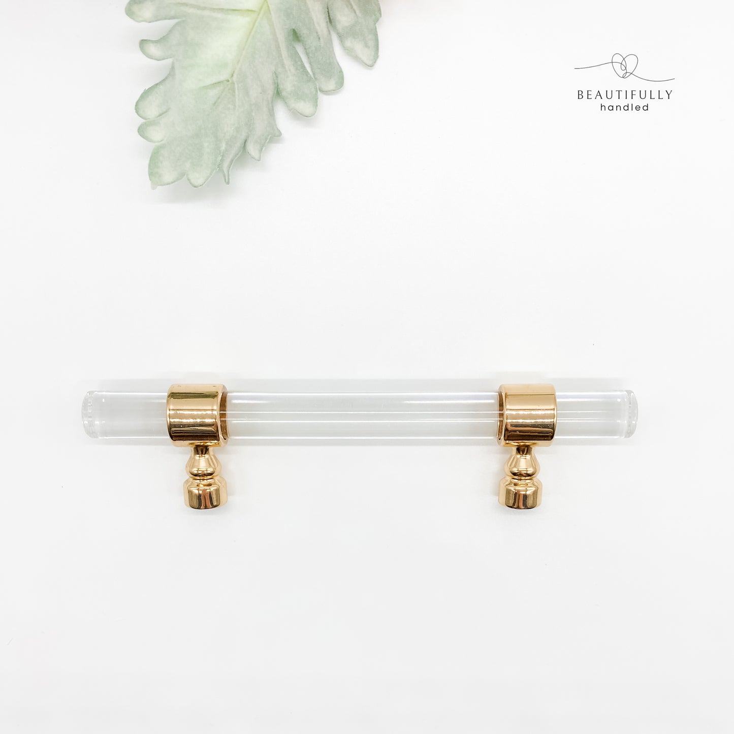 96mm clear acrylic with gold clasp drawer handle on plain white background