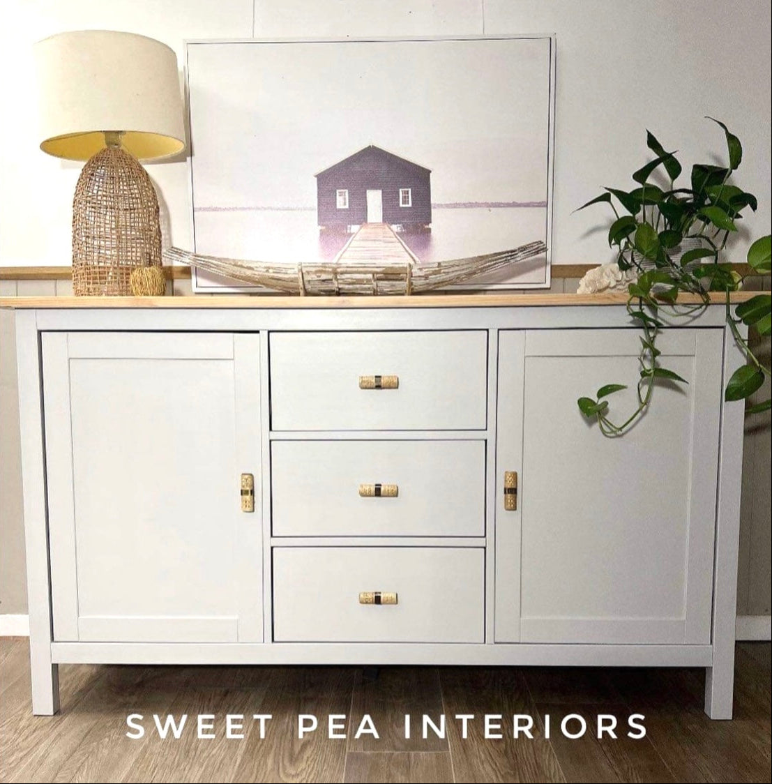 Coastal style buffet with rattan lamp featuring rattan drawer handles 