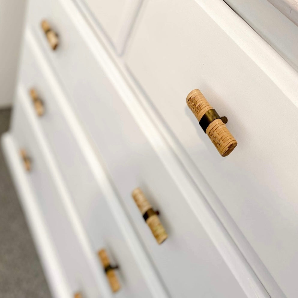 white chest of drawers with close up of rattan drawer handles