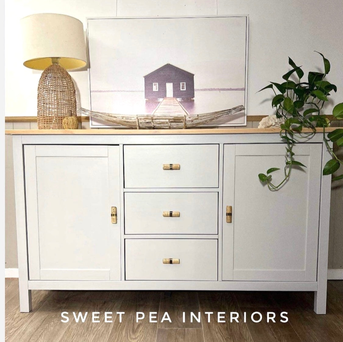 Coastal style buffet with rattan lamp featuring rattan drawer handles 